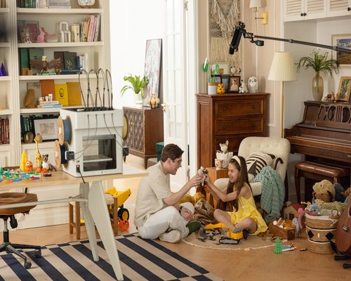 Father playing casually with kids in living room